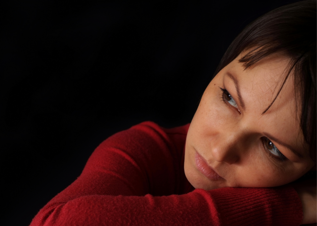 Grieving woman with head on table