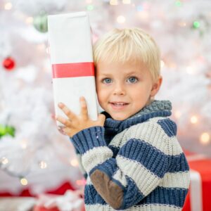 Little boy holding present.